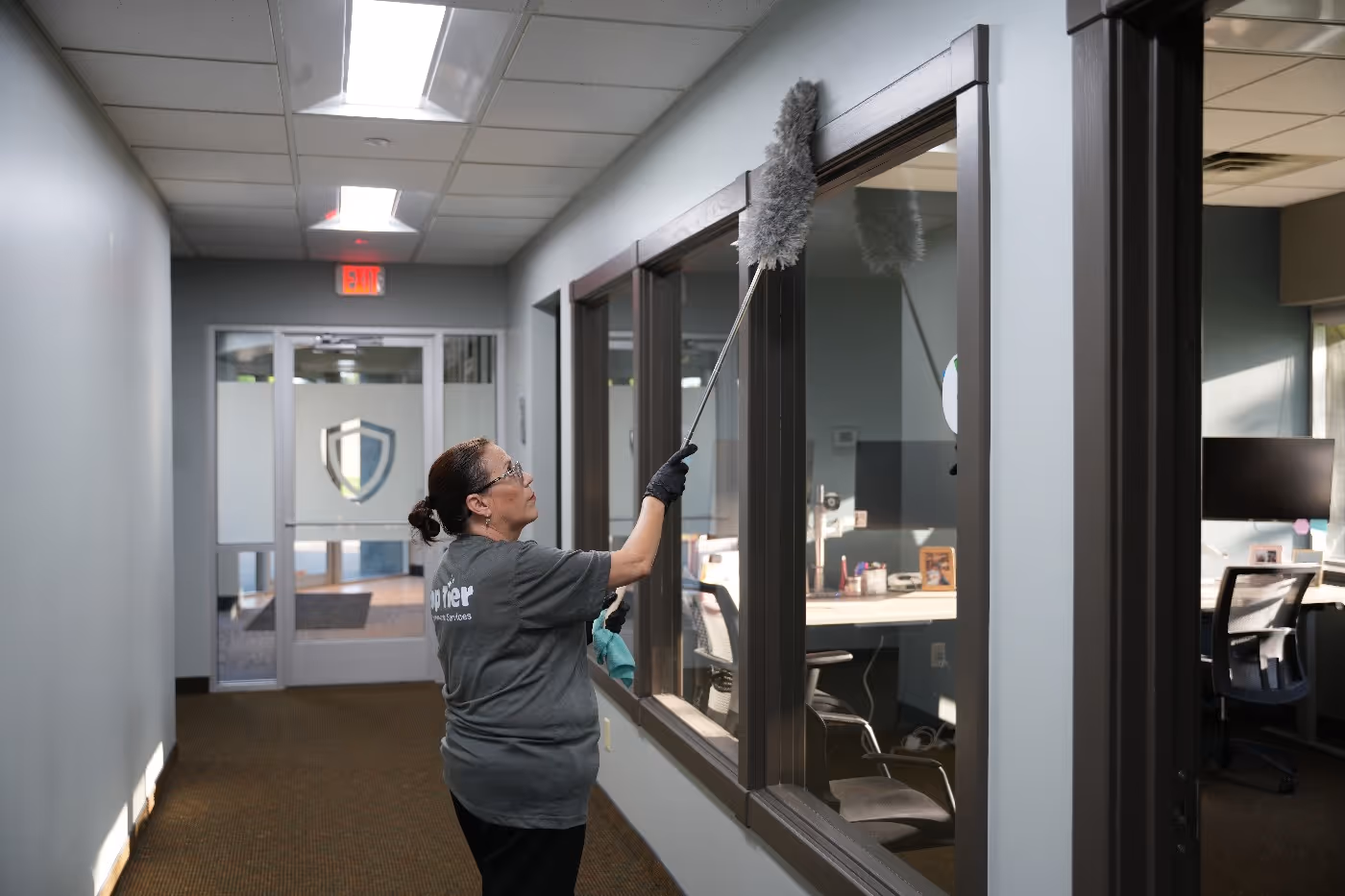 Top Tier Environmental Service workers performing a commercial cleaning service in office space
