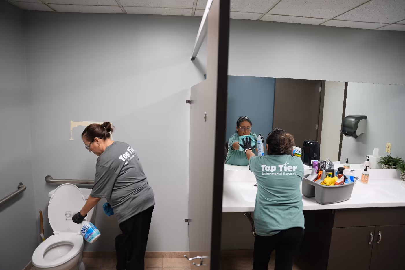 Top Tier Environmental Service workers performing a commercial cleaning service in office space