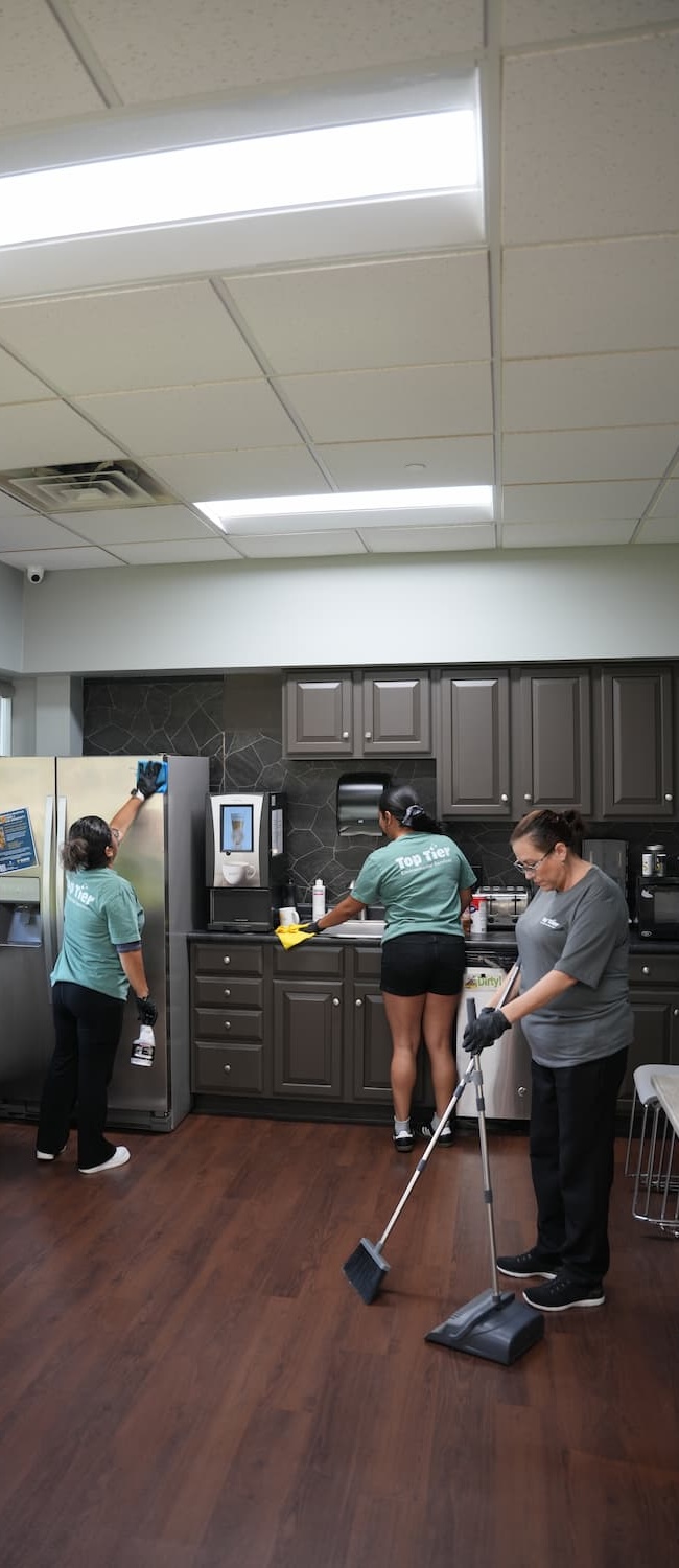 Top Tier Environmental Service workers performing a commercial cleaning service in office space