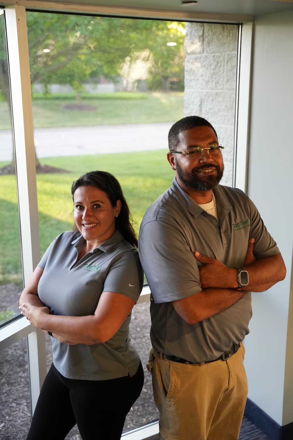 Top Tier Environmental Services owners posing side by side