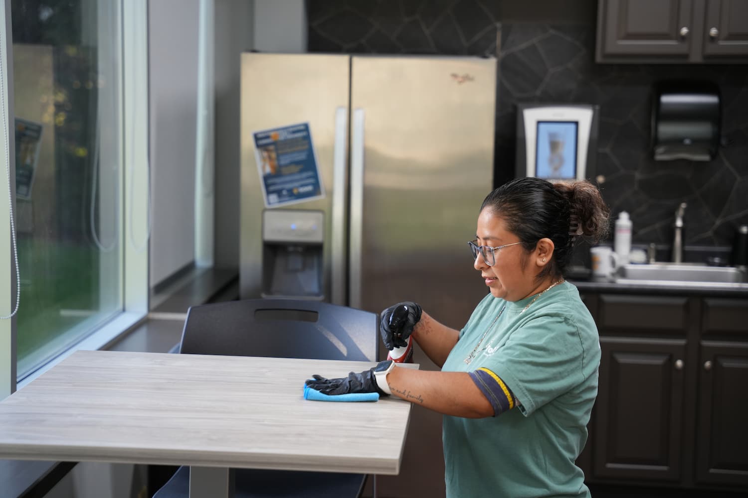 Top Tier Environmental Services crew member wiping table
