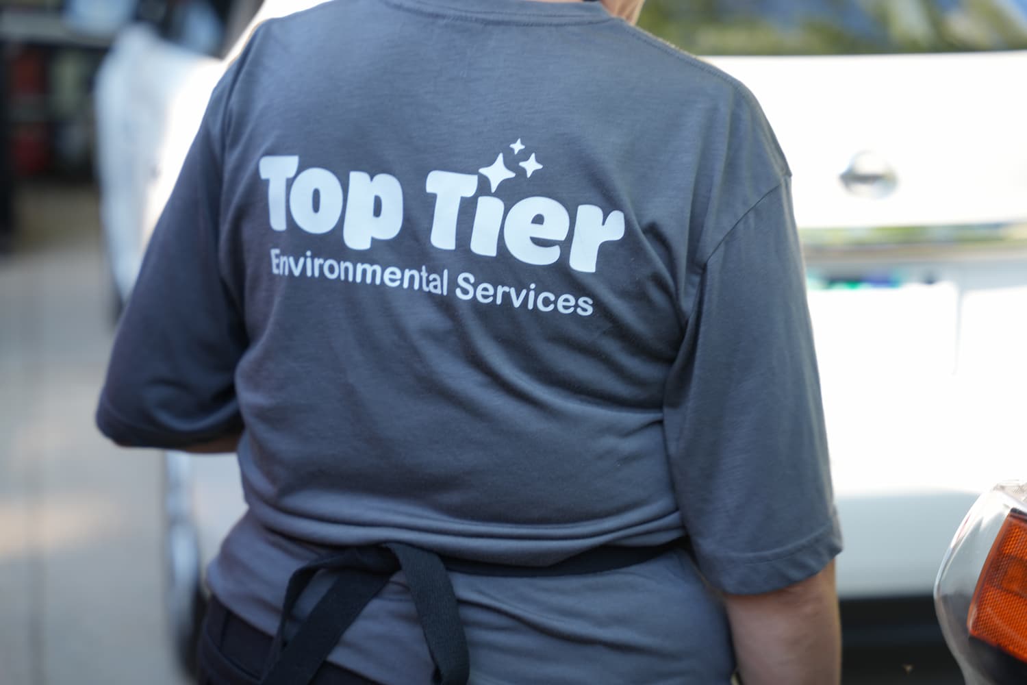 Back view of Top Tier Environmental Services T-shirt on crew member 