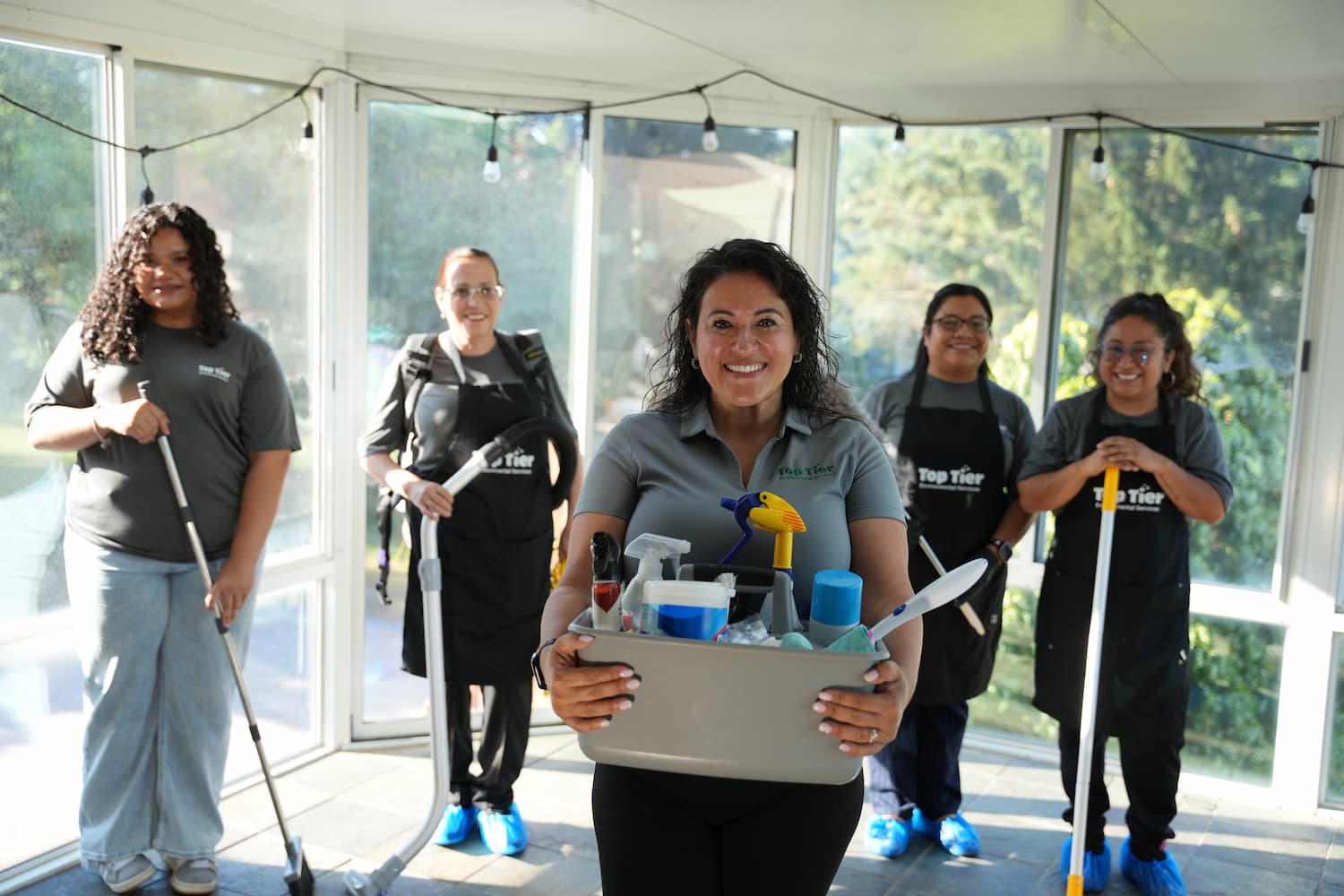 Top Tier Environmental Services crew posing with cleaning equipment