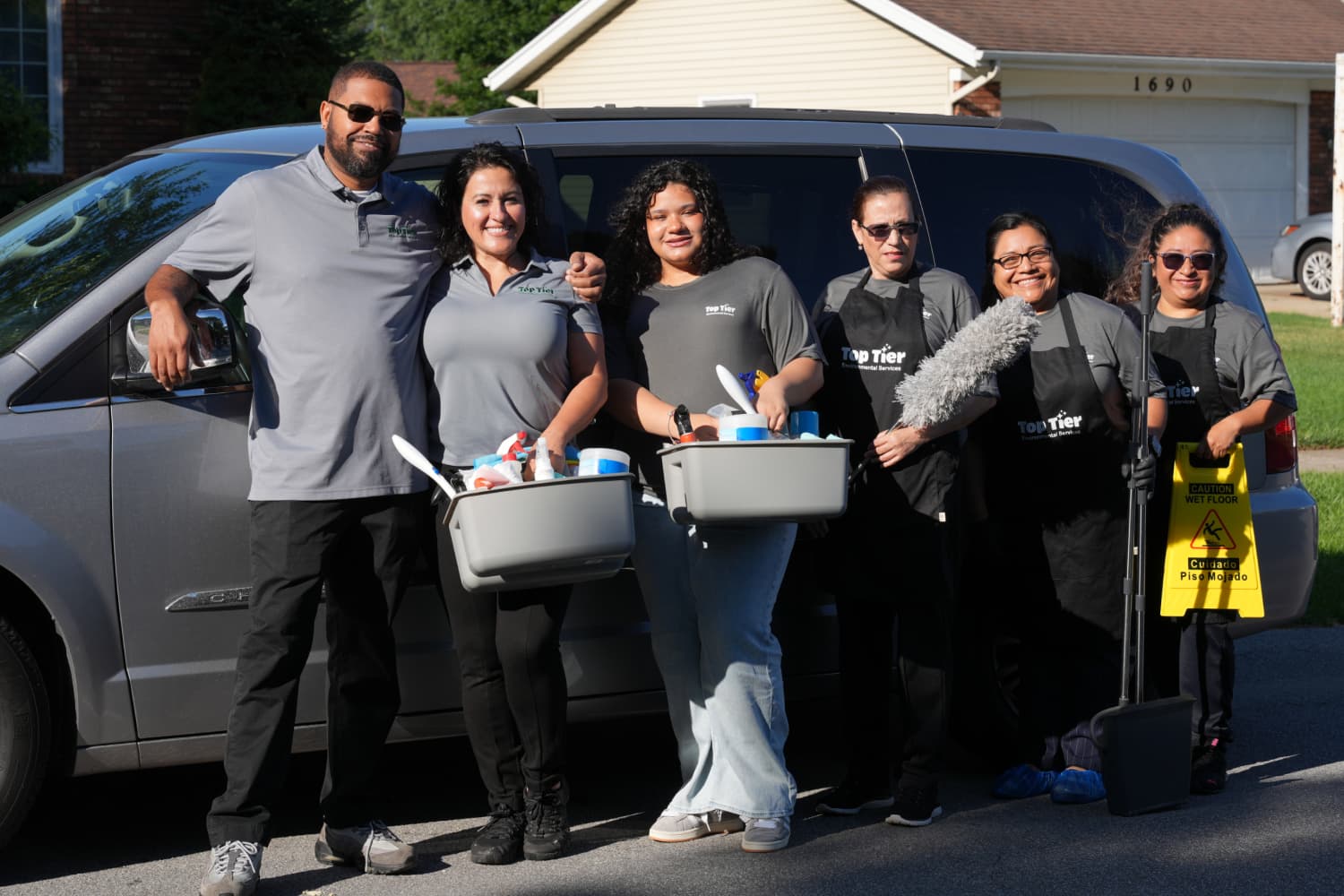Top Tier Environmental Services crew posing in front of company van