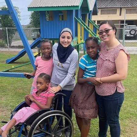 Group of people smiling in a playground.