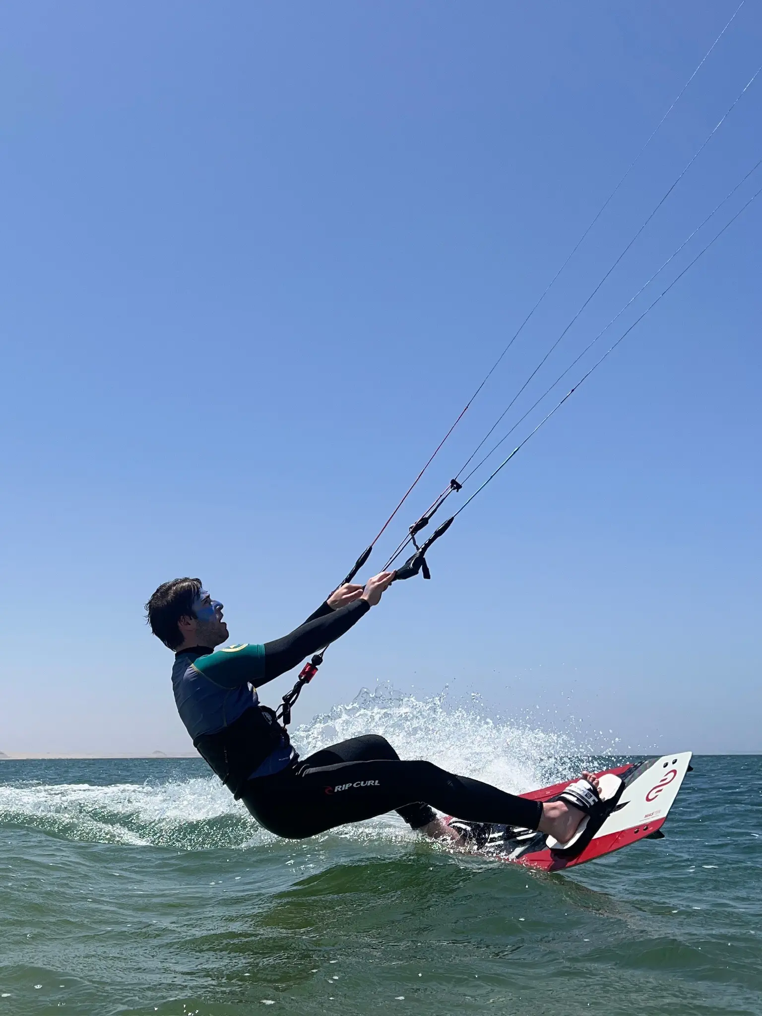 Kitesurfer riding over small waves during a session at Dakhla Lagoon in Morocco.