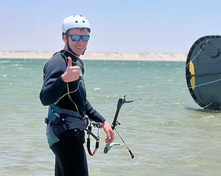Kitesurf student giving a thumbs up during a lesson in Dakhla Lagoon.