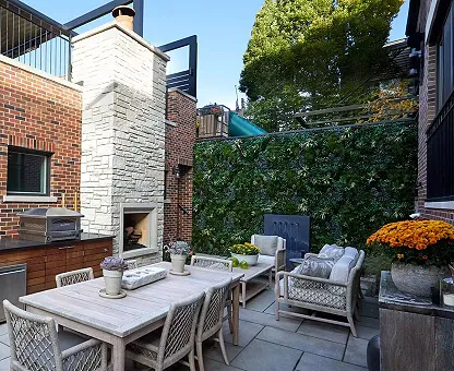 Outdoor patio area with a wall accented in artificial plant walls.