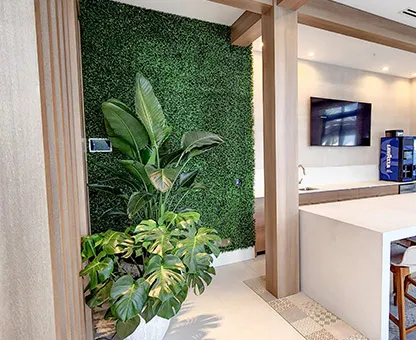 tall wall covered in uniform artificial plant wall.