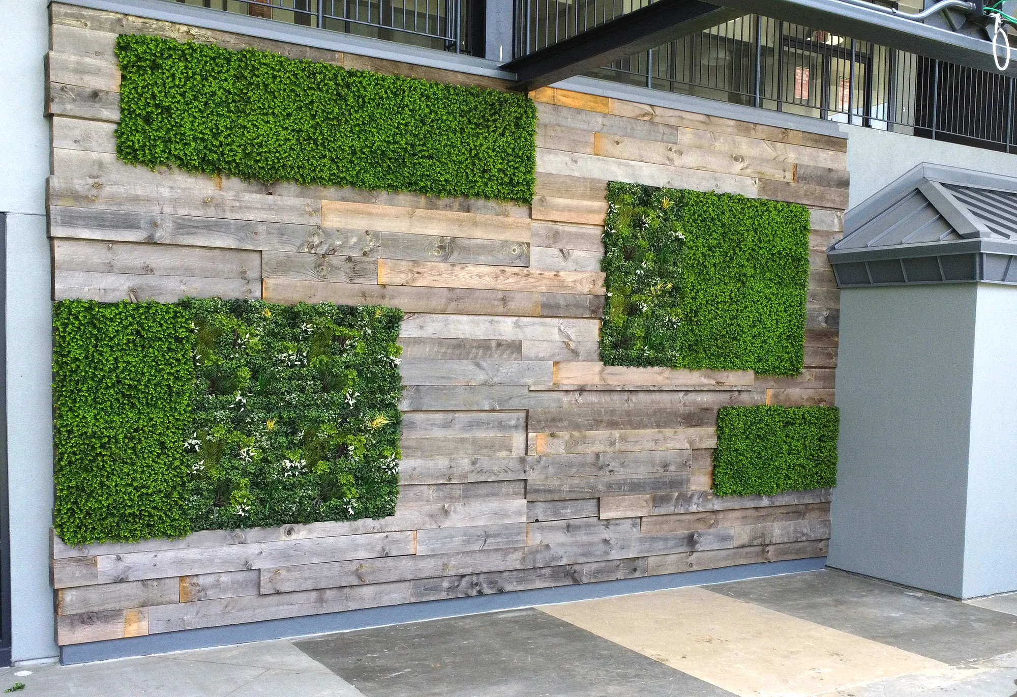 Outdoor wall with patches of artificial living walls