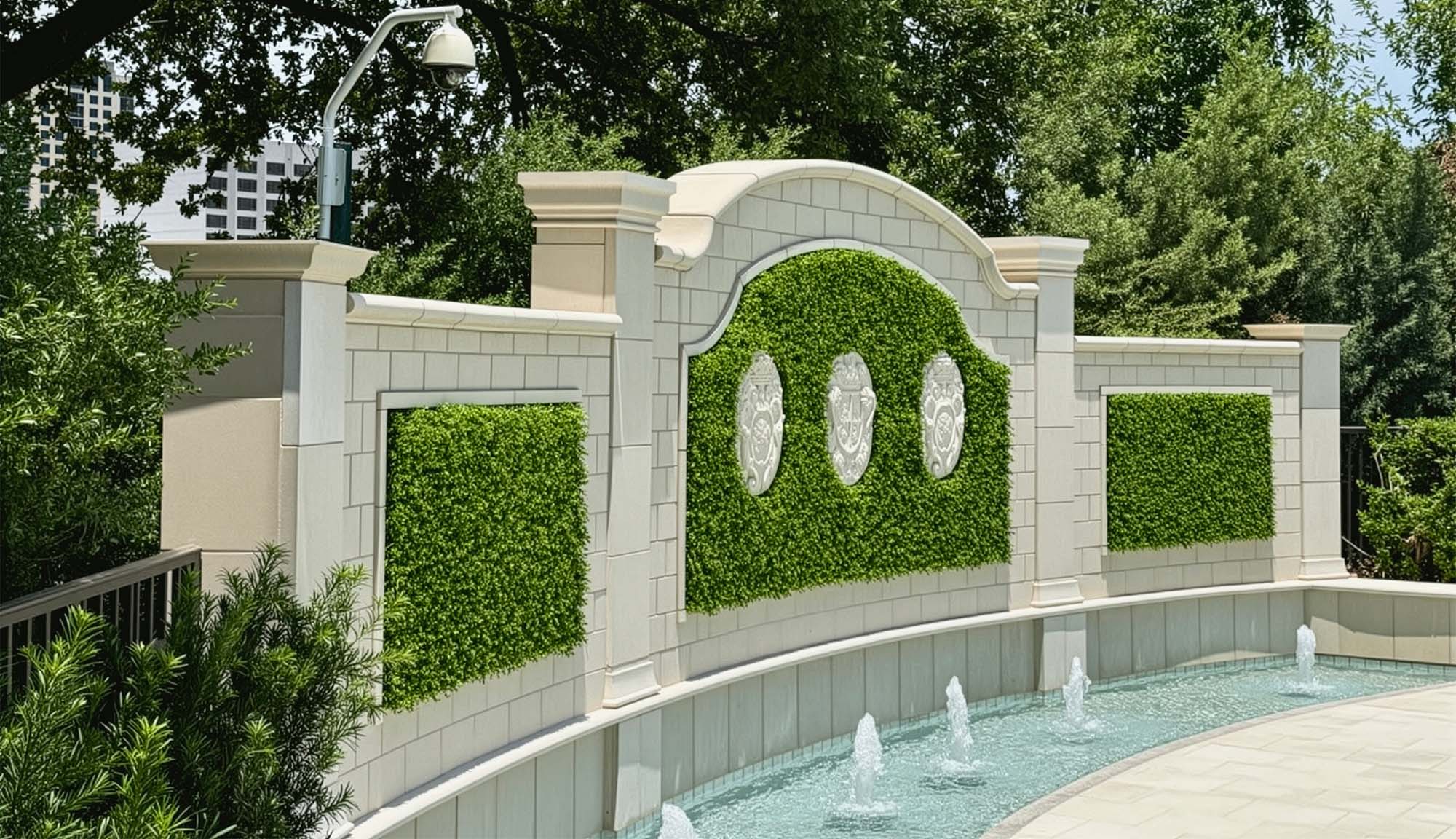 White masonry bricks and artificial living walls on the backside of a fountain wall
