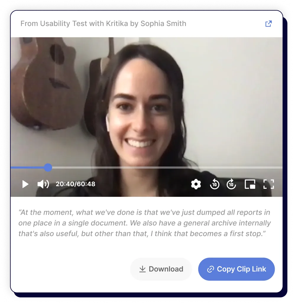 Woman with long dark hair smiling during a video call with acoustic guitars visible on the wall behind her.
