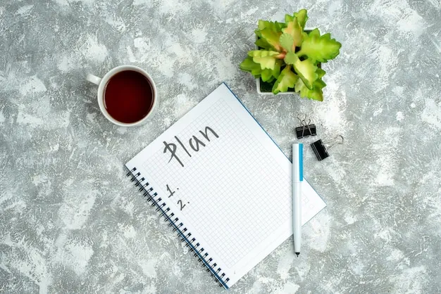 Free Photo overhead view of written spiral notebook and flower pot a cup of tea on gray background