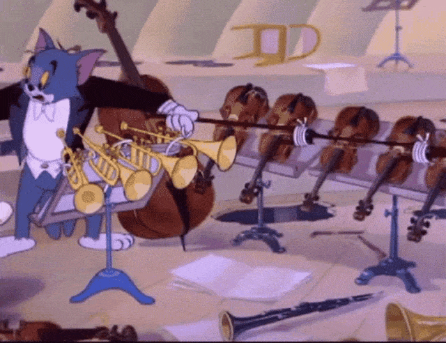 A GIF showing Tom from Tom & Jerry trying to play multiple instruments at the same time