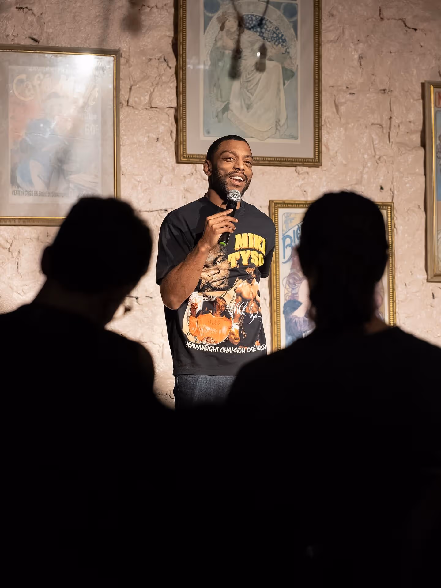 Comedian performing on stage at Fresh Produce Comedy show.