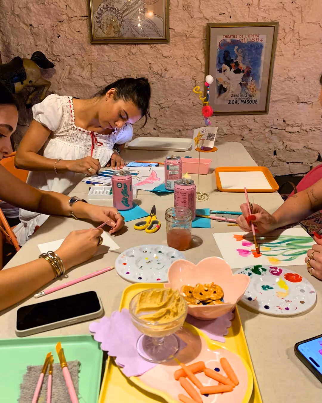 Participants painting and crafting with supplies and snacks at Art Café.