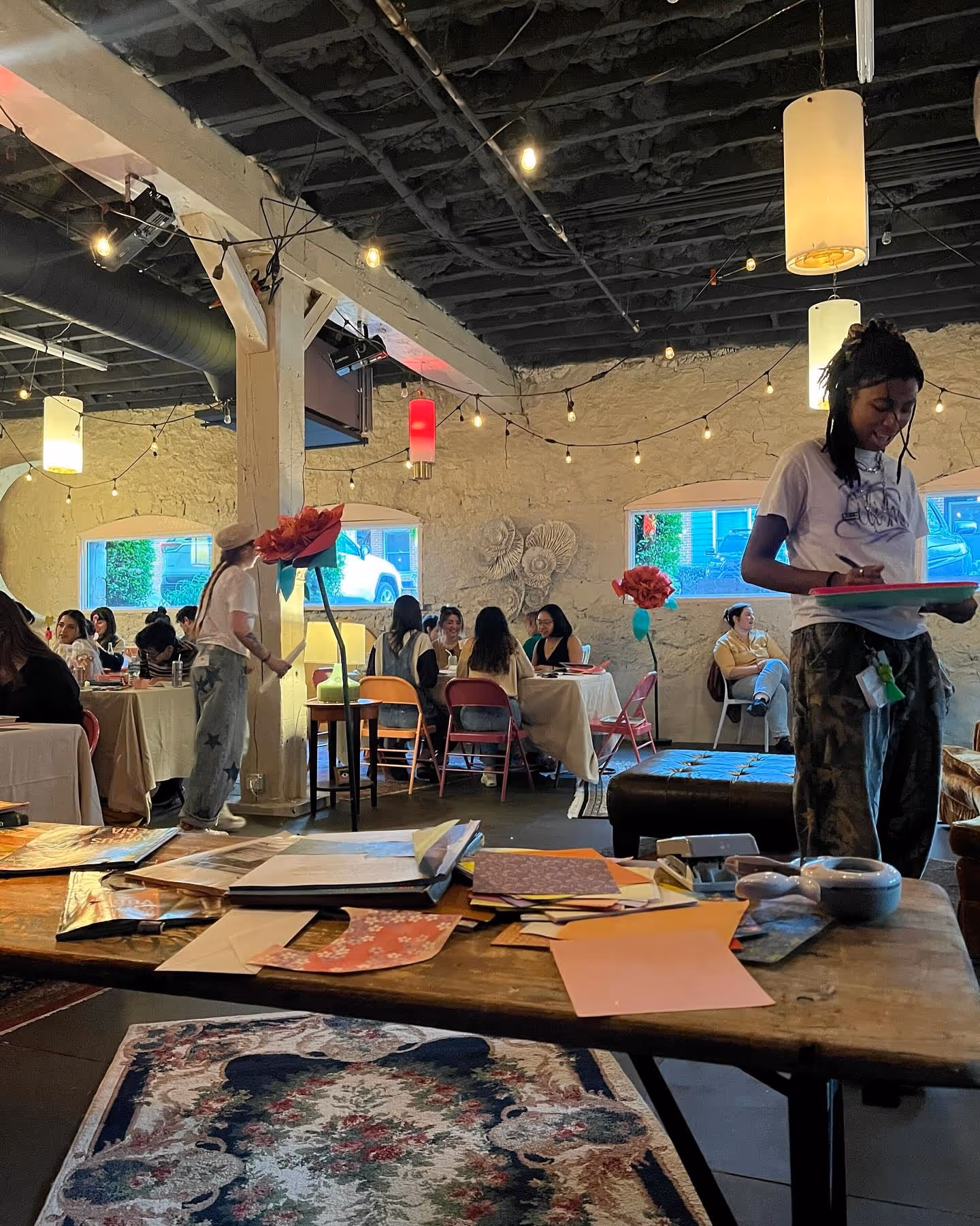 Guests painting and creating at Art Café tables inside The Supermarket.