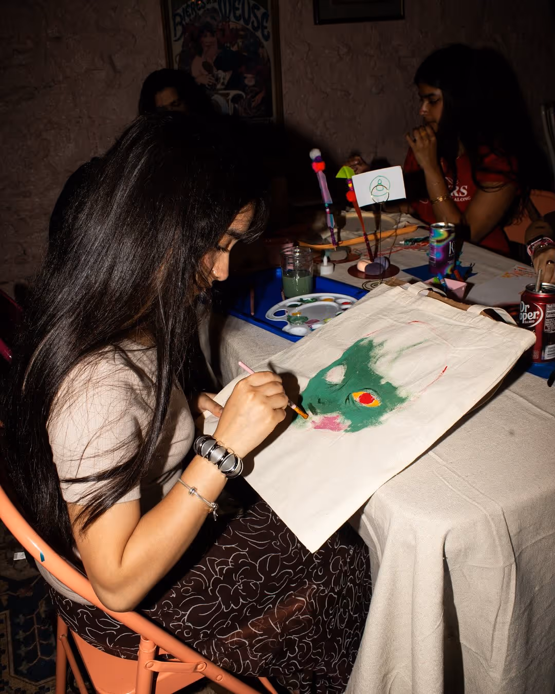 Guest working on a painting project during Art Café.