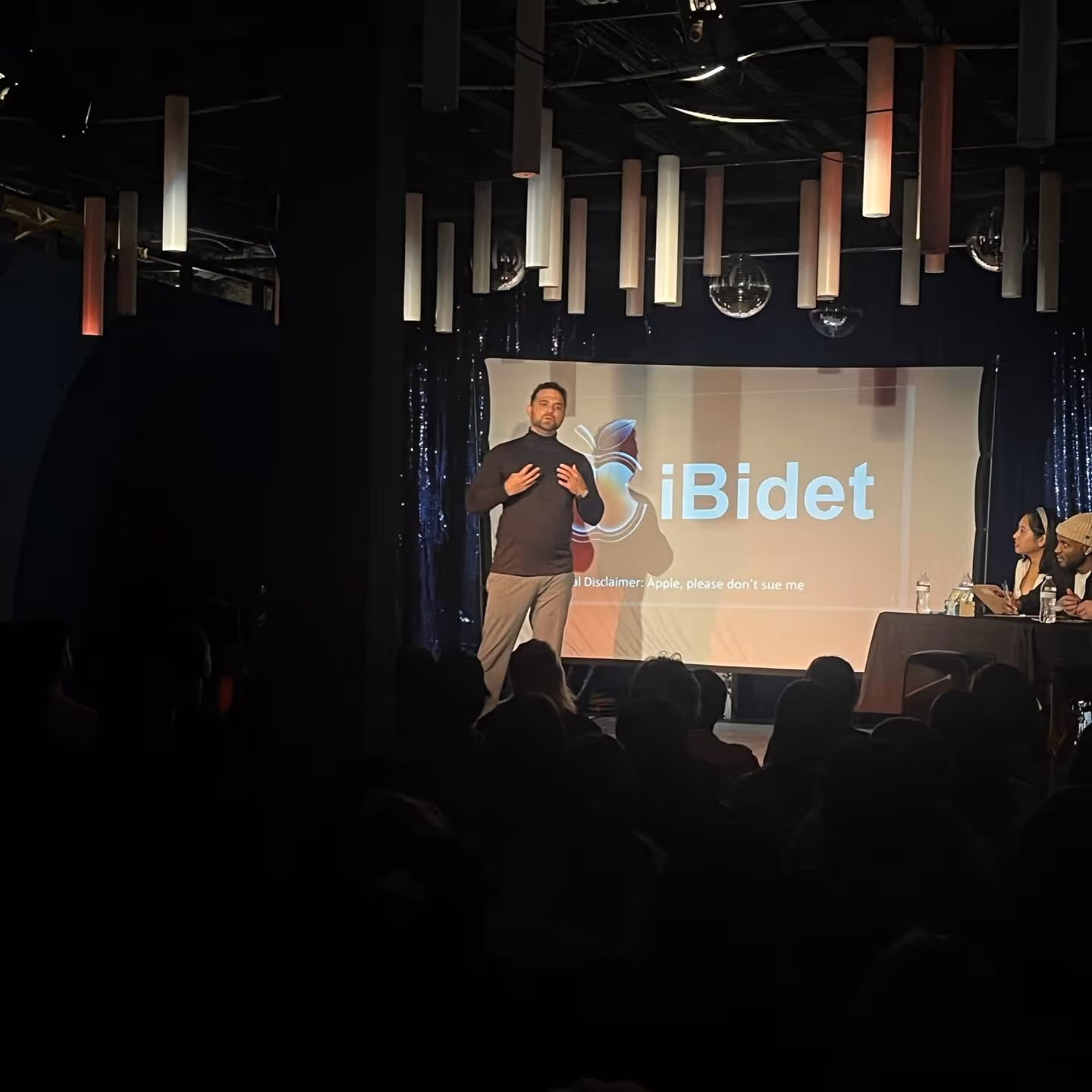 Comedian presenting a satirical PowerPoint to judges at Soapbox.