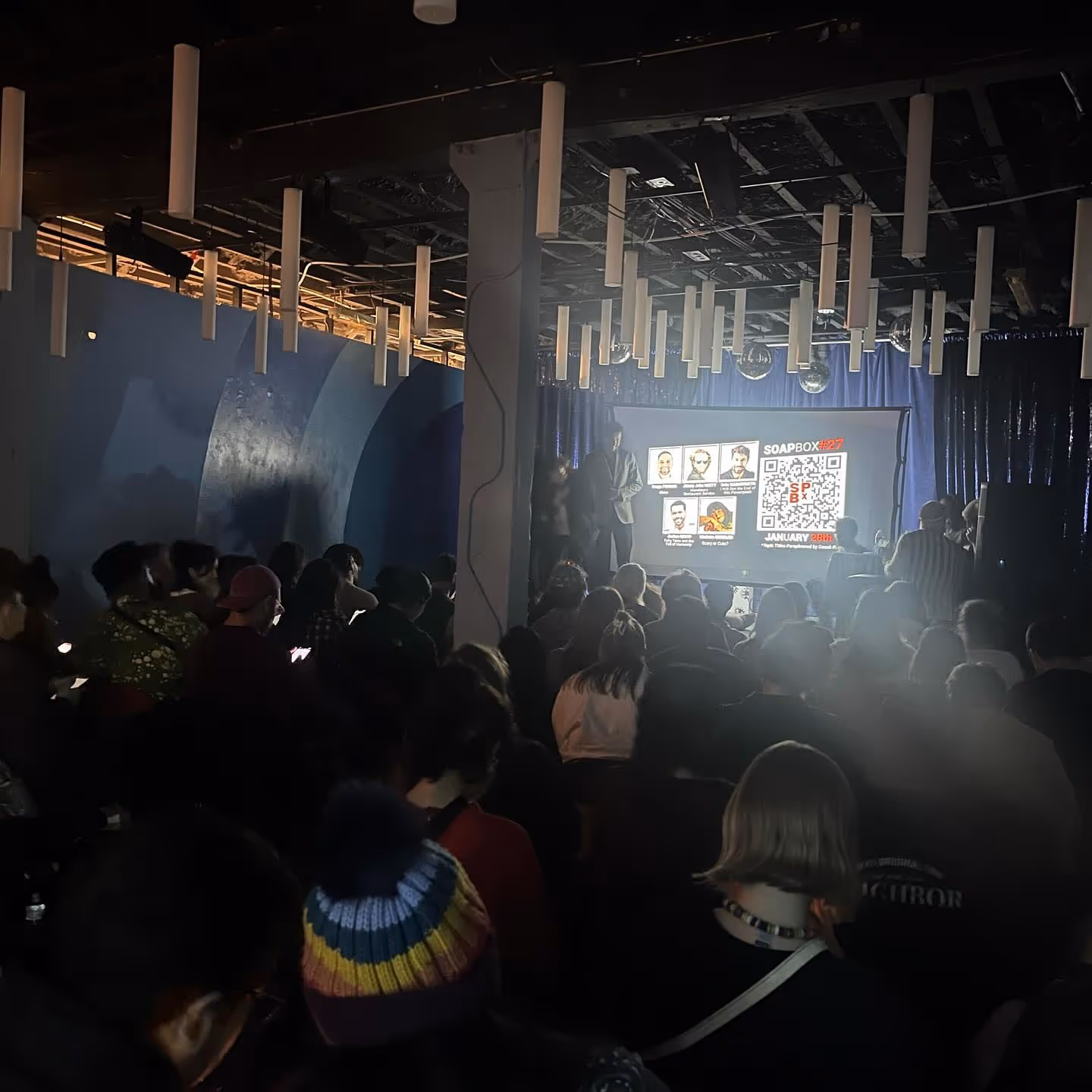 Audience watching a Soapbox comedy presentation at The Supermarket.