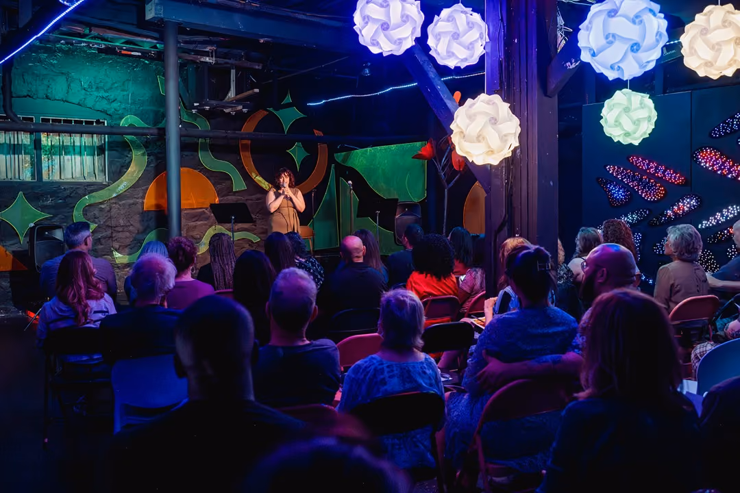 The Supermarket's Black Box room set for a seated audience, a clean stage-forward layout suited to a private performance.