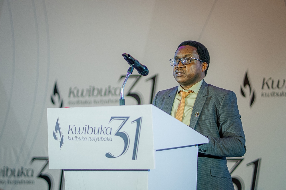 Genocide Research Analyst, Dr Emmanuel Hakizimana, speaks on behalf of the Ministry of National Unity and Civic Engagement addresses mourners at Kigali Genocide Memorial