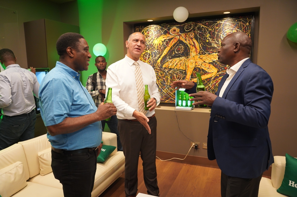 Etienne Saada, Managing Director of Bralirwa Plc chats with other attendees during the crucial event of the signing ceremony.