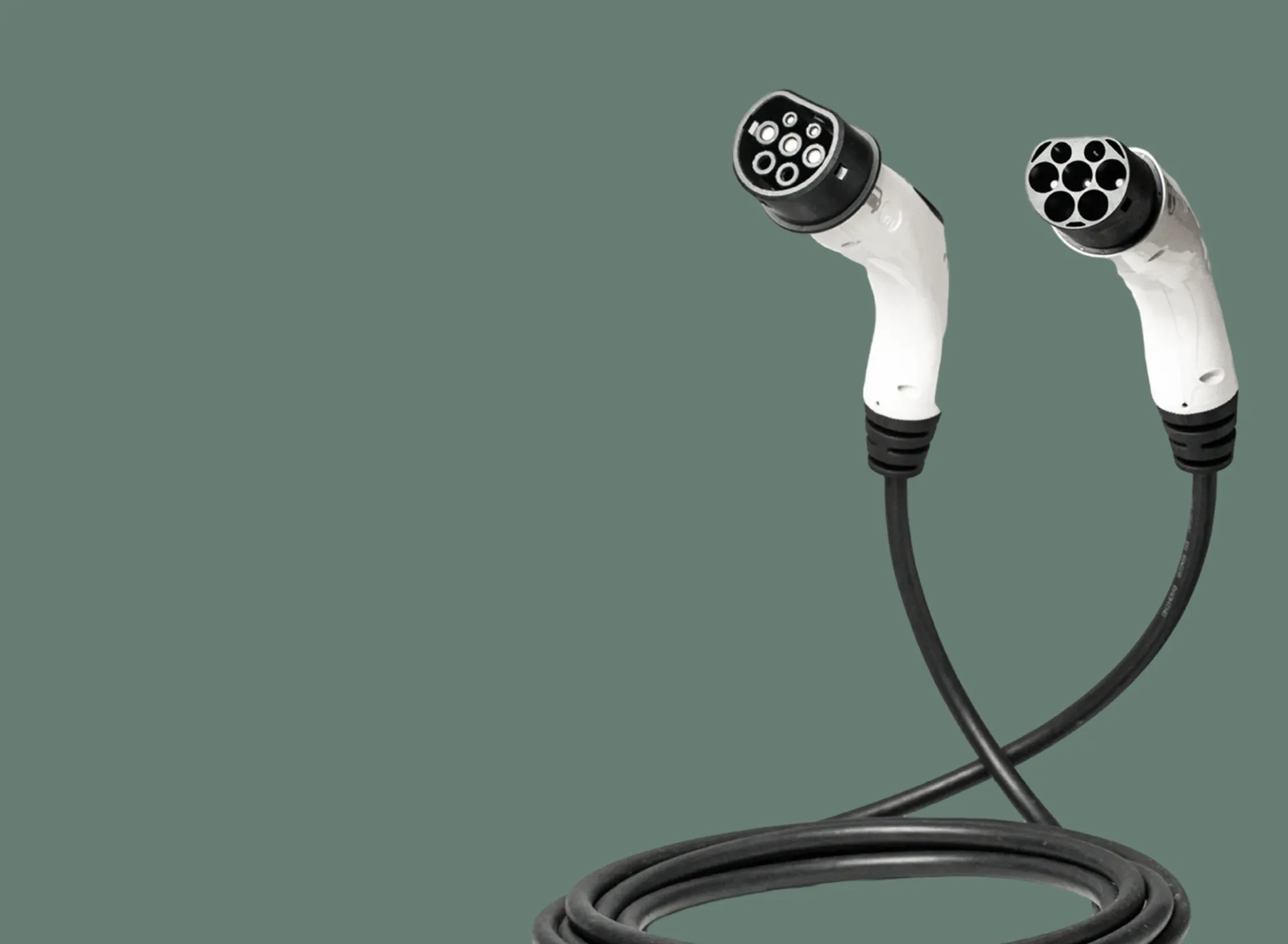 Two white electric vehicle charging connectors with black cables coiled below, set against a green background.