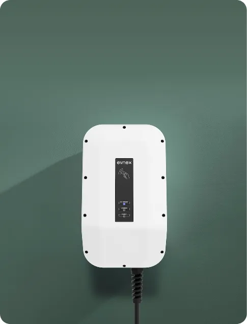 White EV charging station with evnex logo mounted on a green wall.