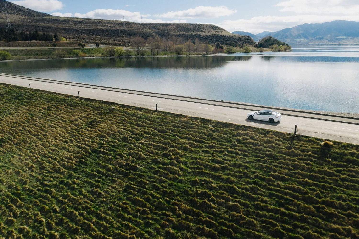 Tesla Model 3 EV driving in New Zealand's South Island