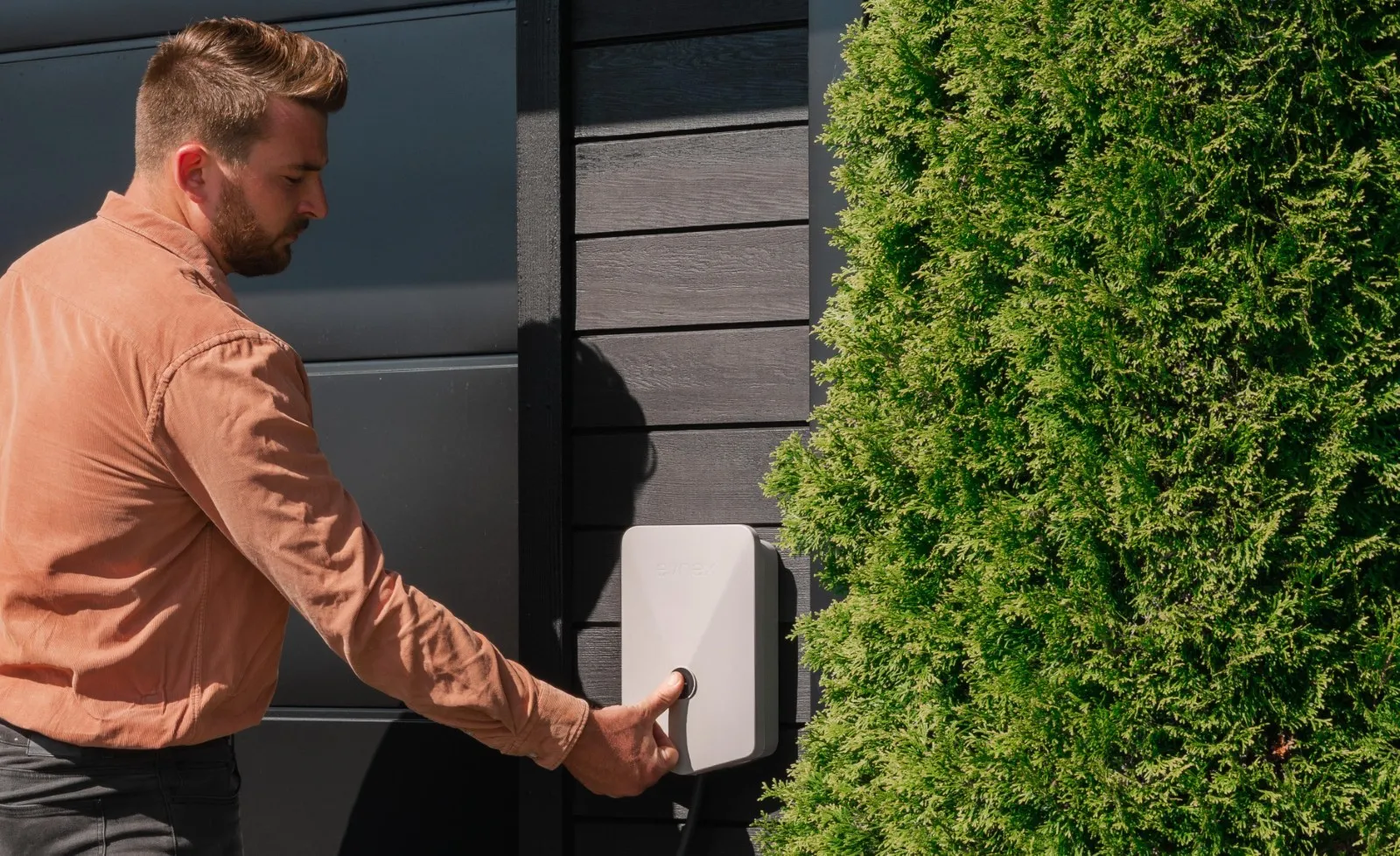 An Evnex E2 smart EV charger being pushed by customer to start smart charging now.