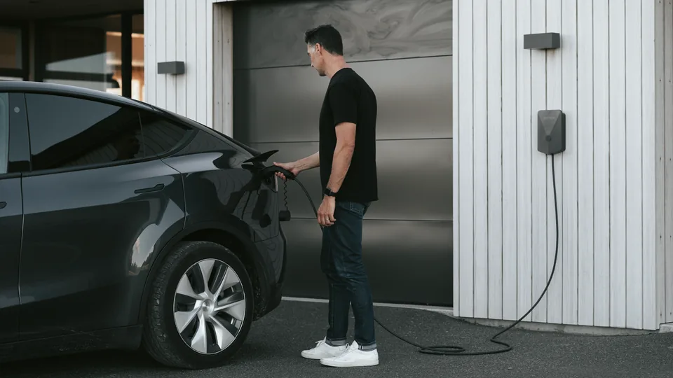 Man charging tesla with an Evnex smart EV charger in Queensland