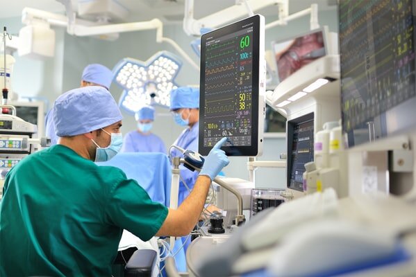 a photo of surgeon with a digital interface during operation