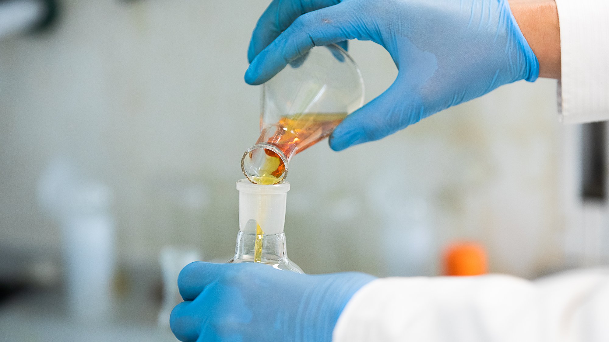 A photo of liquid from a conical flask being poured into beaker