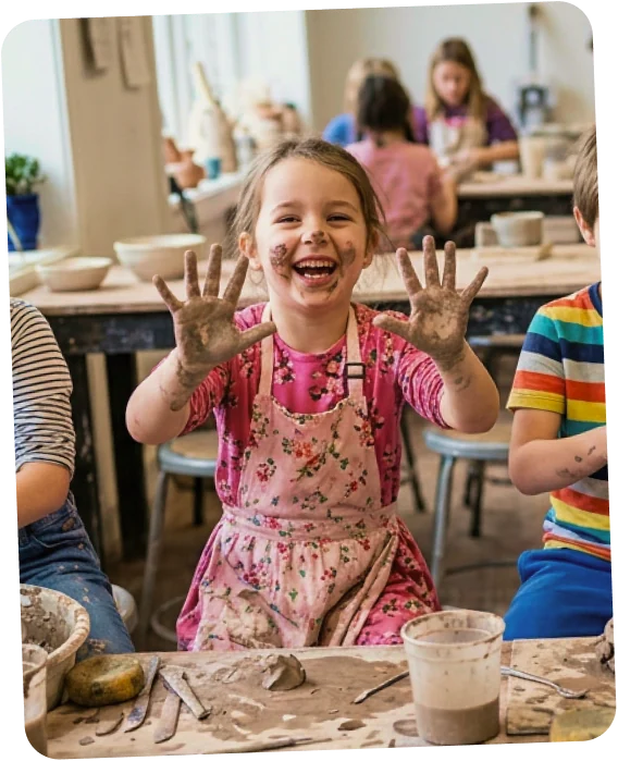 Child making pottery in a class