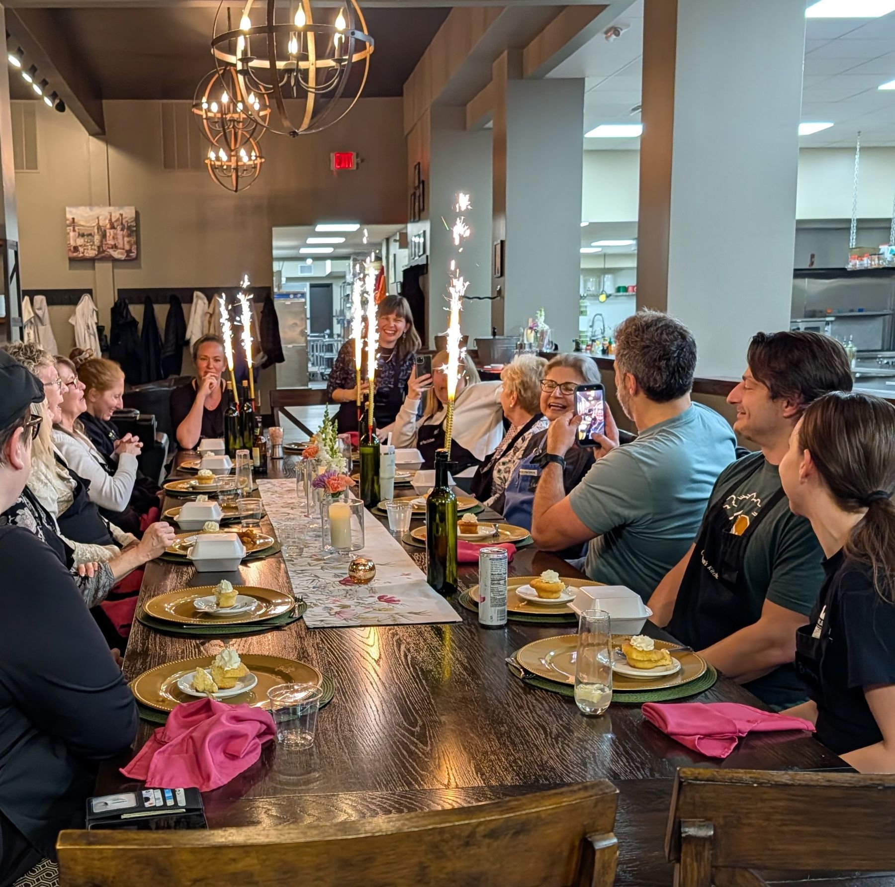 Guests gather around the table for dinner at Chef Pam's Kitchen