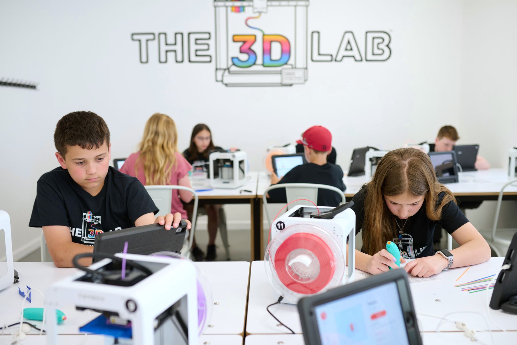Kids at work on 3D printers at The 3D Lab