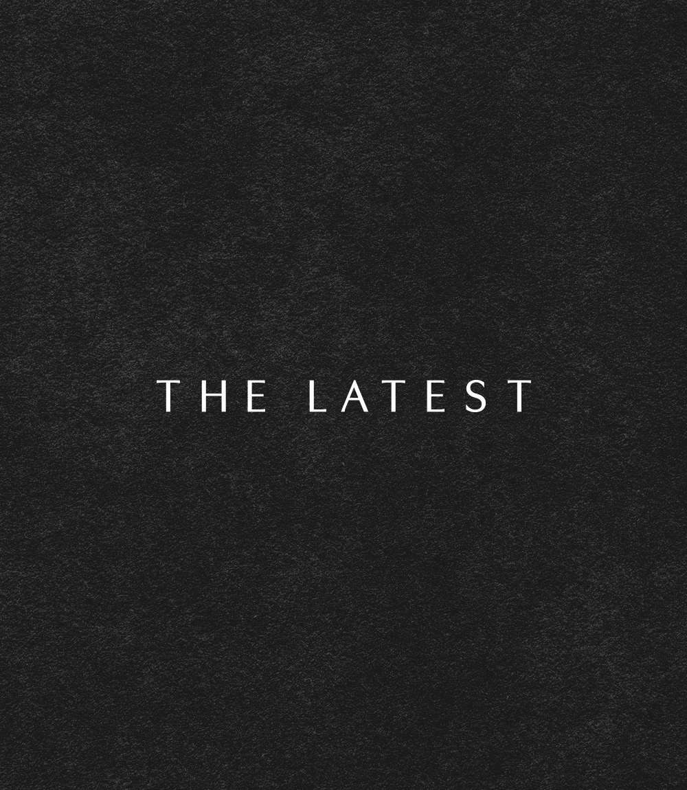 White text reading 'THE LATEST' centered on a black textured background.