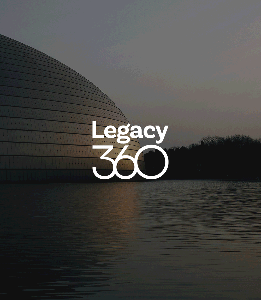 Modern curved building by water at sunset with the text 'Legacy 360' in white in the center.