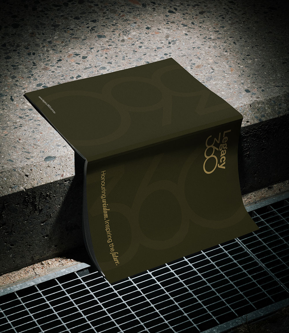 A dark-themed book titled 'Legacy 360' resting on a concrete ledge above a metal grate.