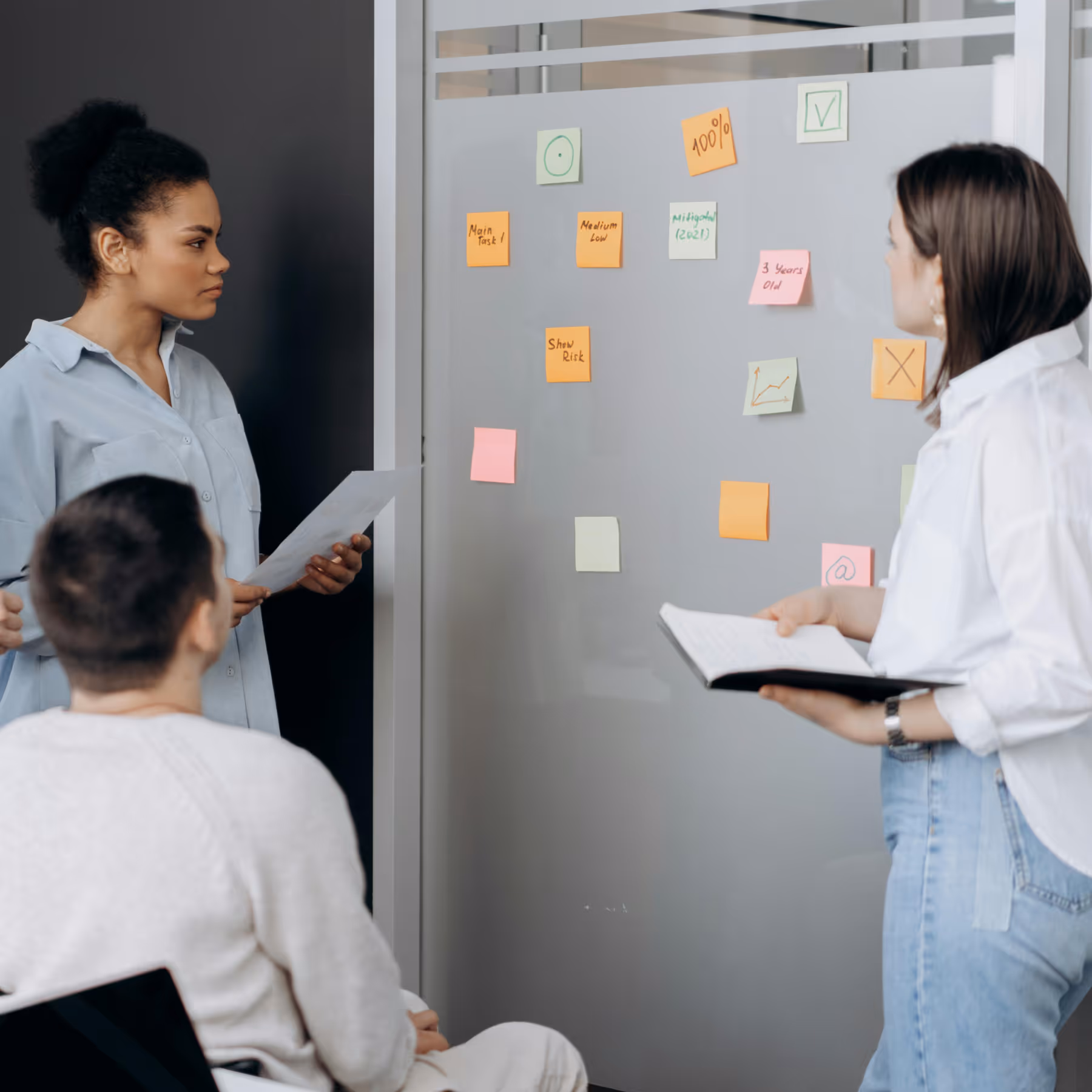 Three product leaders at a board, brainstorming health tech startup ideas