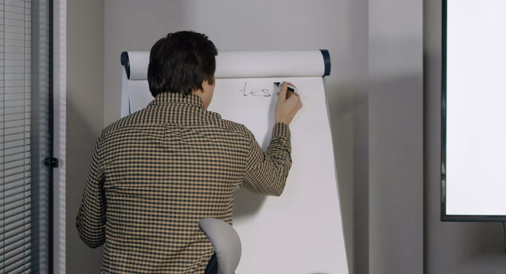 A developer writing on a whiteboard during a HealthTech MVP scoping session, illustrating the focused planning phase of software development