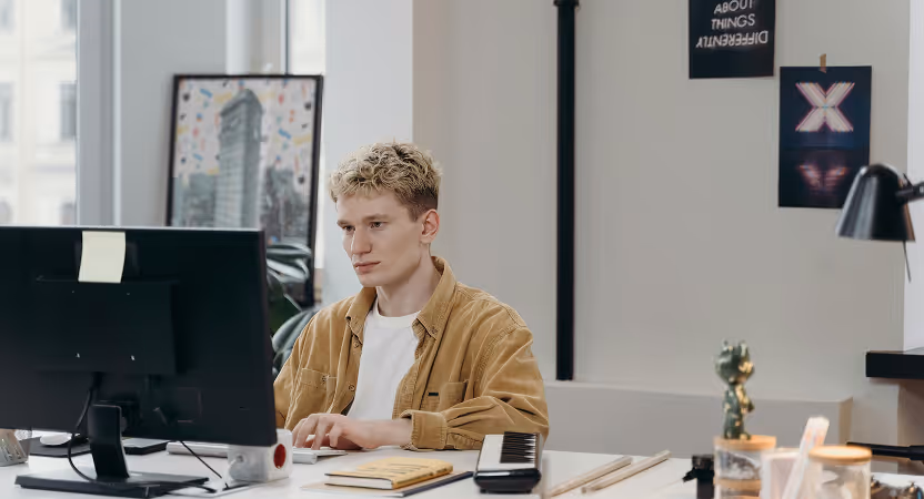 HealthTech startup founder focused on a computer screen in a modern office, working on MVP launch and go-to-market strategy