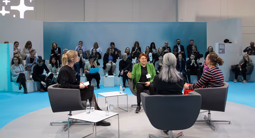 Panel discussion at DMEA Berlin 2025 featuring healthcare leaders in a circular stage setup, engaging with a seated audience.