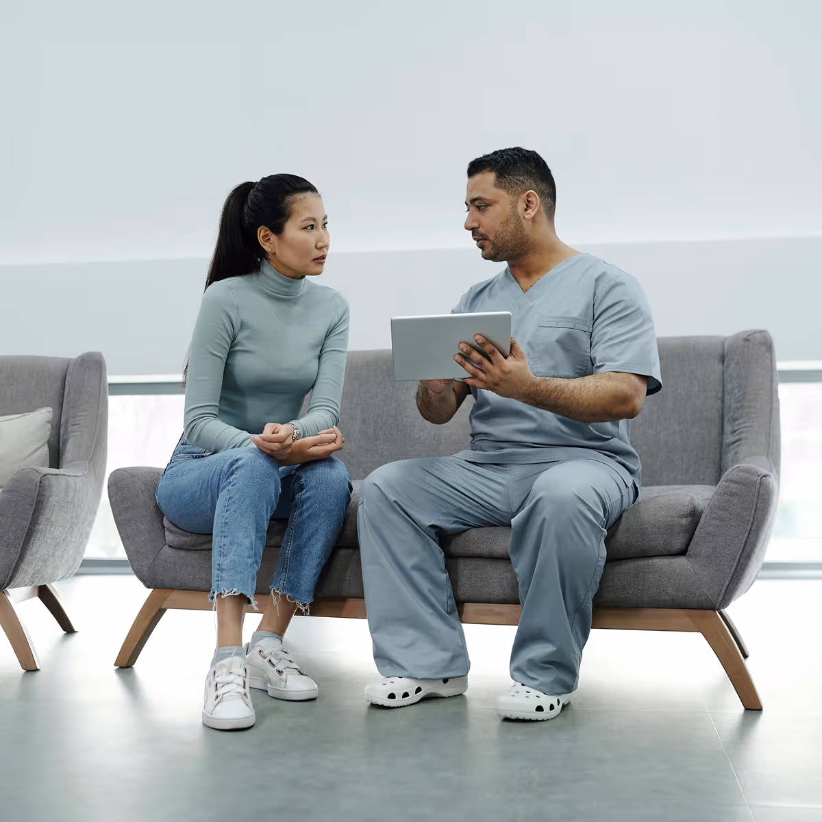 Healthcare provider explaining HIPAA compliance requirements to HealthTech startup founder building secure patient-facing MVP