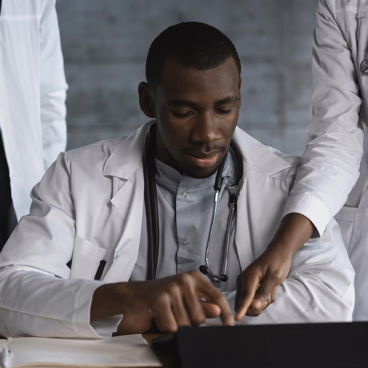 Healthcare professionals reviewing HIPAA compliance protocols and patient data security measures on computer