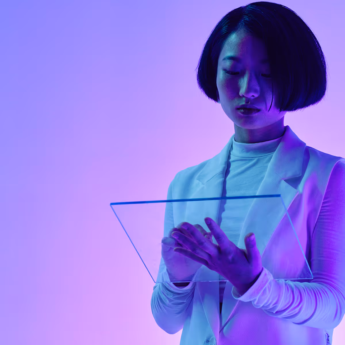 Woman interacting with a transparent digital interface, illustrating healthcare AI applications and precision-driven prompting strategies in clinical settings.