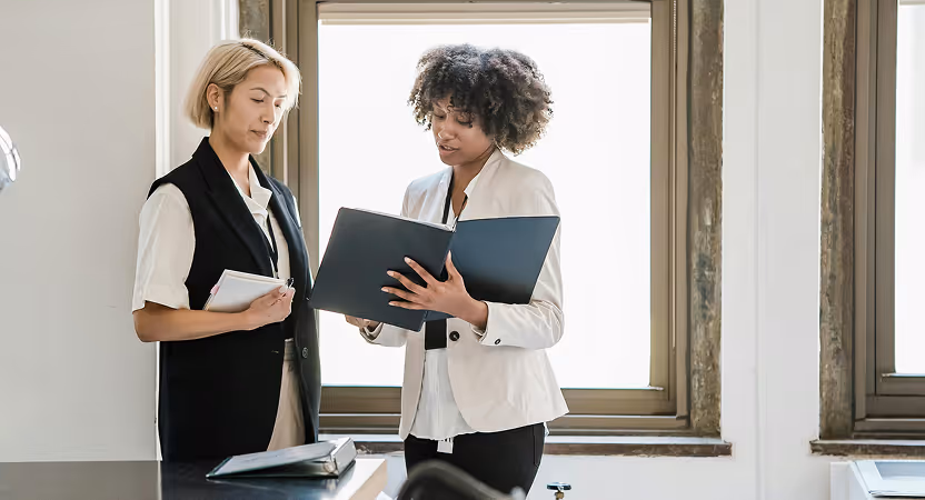 Health Tech product leader discussing resources with a team member