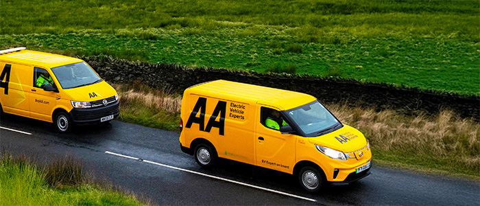 Two The AA service cars driving down a road