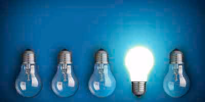 Bright bulb between four turned off, symbolizing innovation and creativity